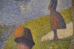 Portion of Seurat pointillism painting showing a closeup of water, grass, and two partial figures